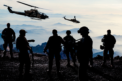 Silhouettes of soldiers during Military Mission at dusk