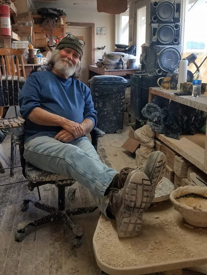 Brad Walker sitting in his shop. 