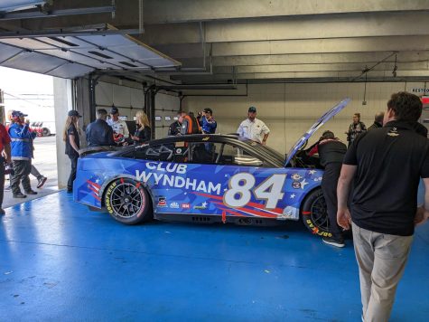 Jimmie Johnson's No 84. Club Wyndham Chevrolet getting serviced in the garage after blowing a rear tire early in the race. Johnson also pictured getting out of the car. Photo by Devin Kupka