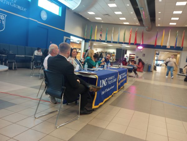 Picture of the moderator and the speakers at the Town Hall