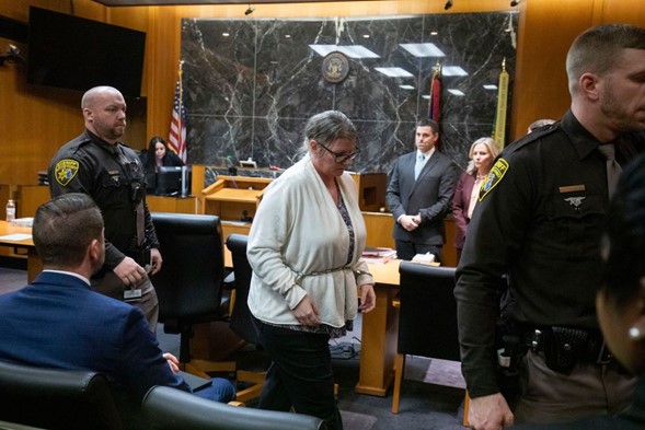 Jennifer Crumbley is escorted from the courtroom by police after her verdict is delivered.