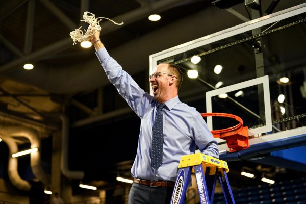 UNG Mens Head Basketball Coach Dan Evans cutting the net after winning NCAA Southeast Regional title. Photo by Ben Lilley
