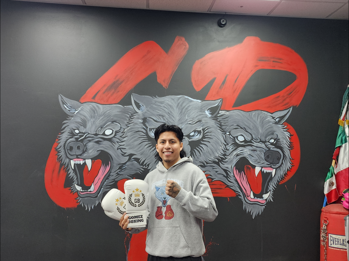 Al Gomez, owner, in front of Gomez Boxing Club’s “Wolfpack” mural.