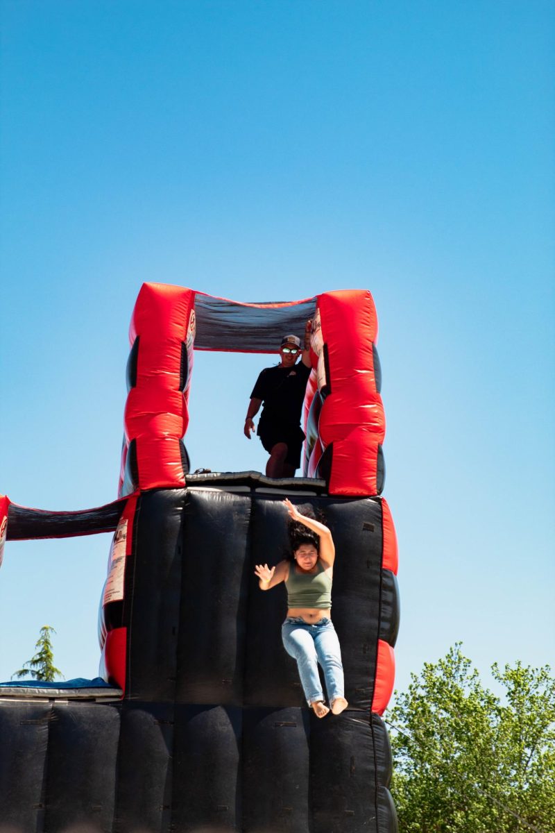 A UNG student leaping from the double bounce slide 