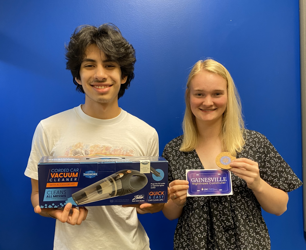 UNG Sophomore Mauricio Gonzalez and Senior Abby Mize show some of the promotional giveaways that students will get throughout the week.