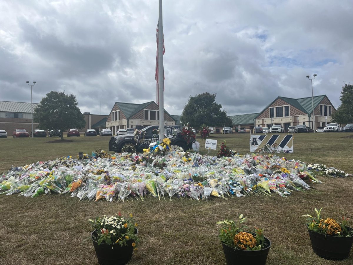 A memorial outside Apalachee High School with flowers, candles, and notes left by the community to honor victims.