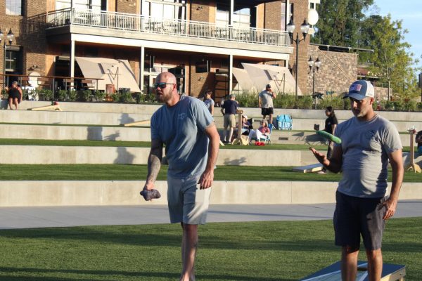 The Hard Standings cornhole team, "Hit-or-Miss" lines up a shot.