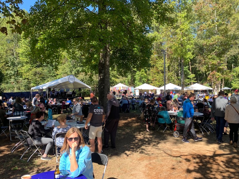 The Cumming Greek Festival had tables filled with attendees eating authentic cuisine while listening to live music. 