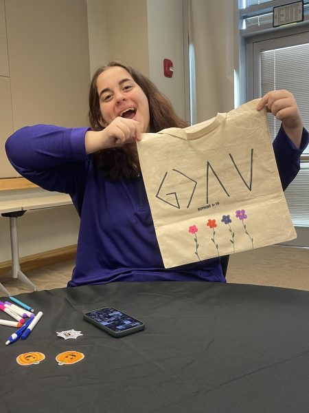 Alyssa Evans shows off her personal tote bag and joyful spirit for raising awareness. 