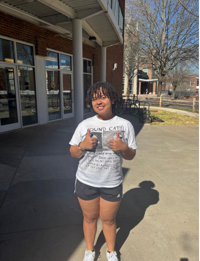 Rayya Abdullah outside of the Hoag Student Center at the University of North Georgia's Dahlonega campus, tables to start the first historically Black sorority on campus.