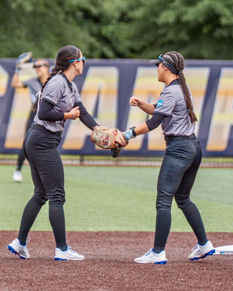 Rylie Moody and Jenna Miles high fiving each other in NCAA National Championship game against Western Washington. Photo by David Trotter 