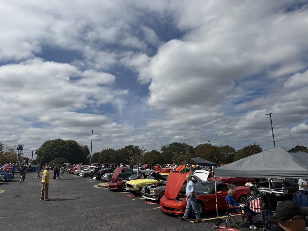 Car enthusiasts experience the sights and sounds of the Secret Santa Car show. 