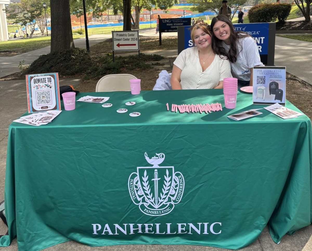 Ally Freigh, Panhellenic President, and Makenzie Burge, VP of Philanthropy and Scholarship, promoting and collecting donations for Circle of Sisterhood.  