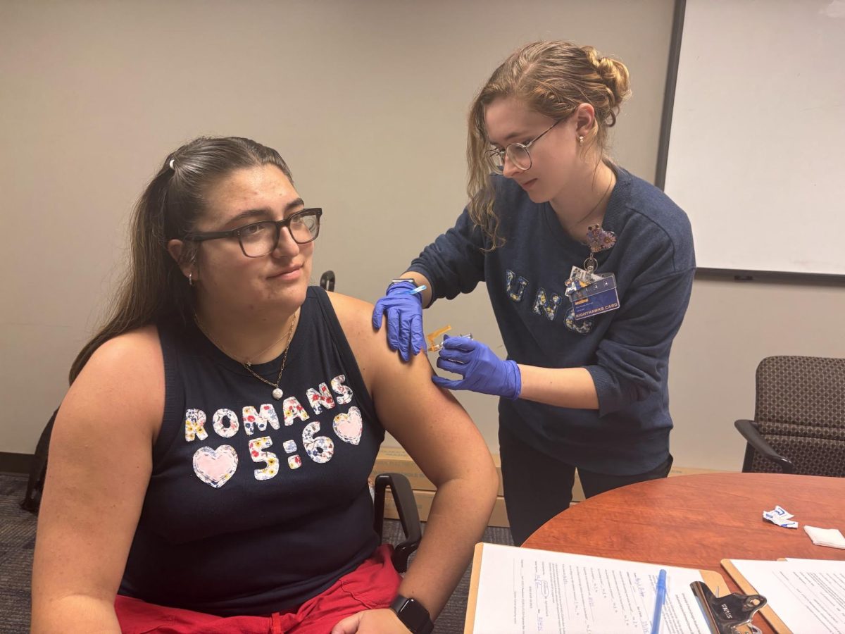 Student receiving flu vaccination at flu shot clinic in the Gainesville Student Center.