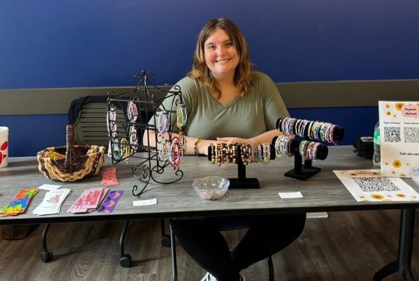 Em Conroy selling at a 2024 CCSM market (Obtained from club Instagram)