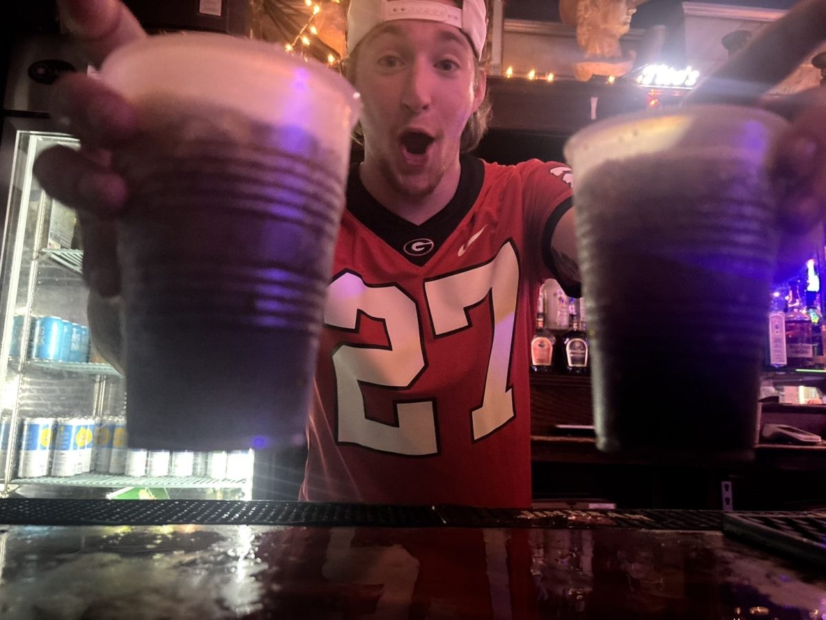 Jack Friedman serving two rum and cokes after a big Bulldawg win over Texas University.