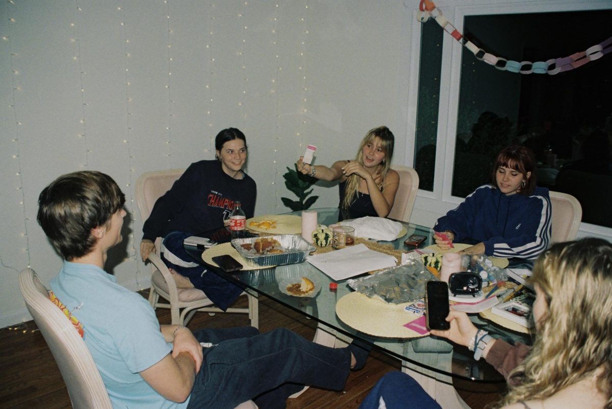 Friends playing a card game. Photo by Ansley McMurry.